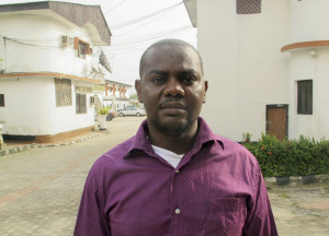 Okene poses for photograph after an interview with Reuters outside an hotel in Nigeria's oil city of Warri