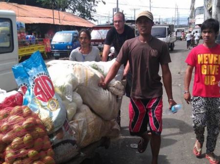 Tony Gilchrist (centre) helped distribute aid following Typhoon Yolanda