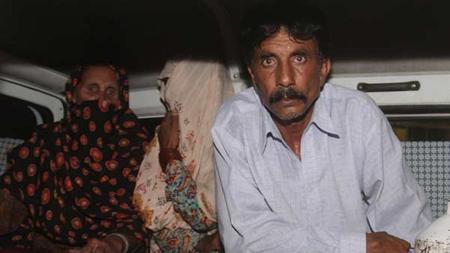 Mohammad Iqbal and members of his family aboard the ambulance carrying his pregnant wife’s bod