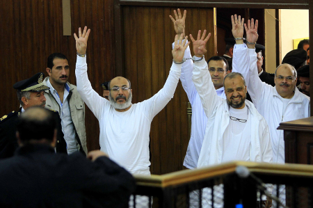 Cleric Safwat Hegazy (left) and Mohamed El-Beltagy are handcuffed together as they arrive in court.