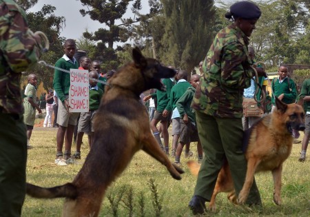 Amazed pupils look on as dogs are brought in to break up their innocent protest