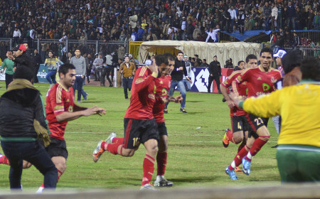 Al-Ahly players flee Al-Masry “ultras” as they invade the pitch. The ensuing riot led to 72 deaths and 21 Al-Masry rioters being sentenced to death
