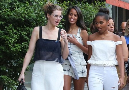 Malia (centre) and Sacha (right) out and about in Milan. Be assured, their security entourage was not limited to the other young lady in the picture
