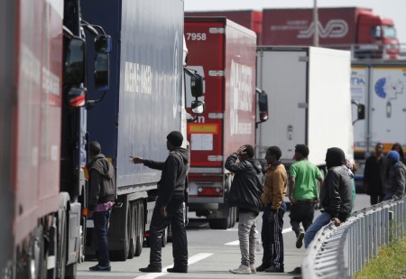 In broad daylight, migrants look for UK-bound lorries to board