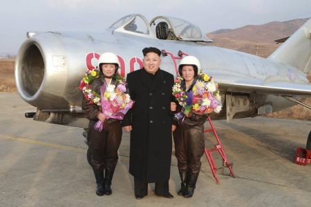 Smiling pilots Jo Kum Hyang and Rim Sol pose with the supreme leader of the Democratic People's Republic of Korea