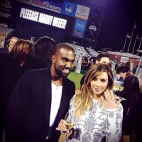 Kanye West and Kim Kardashian shortly after she accepted his marriage proposal at a San Francisco baseball field