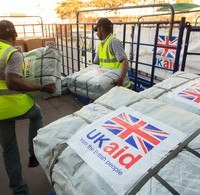 UK Aid Shelter Kits and Water Containers are loaded for shipment