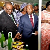 Vice President Osinbajo declared open the Nigeria Diaspora Day 2015. VP at the exhibition stand with  Engr. Aiyegbusi Chairman of Yem Yom Ventures producers of Olu Olu Foods and Hon. Abike Dabiri on the right.
