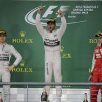 Mercedes driver Lewis Hamilton, of Britain, celebrates after winning the world championship win his victory at the Formula One U.S. Grand Prix auto race at the Circuit of the Americas, Sunday, Oct. 25, 2015, in Austin, Texas. Left is teammate Mercedes driver Nico Rosberg, of Germany, and Ferrari driver Sebastian Vettel, right, of Germany,. (AP Photo/Eric Gay)