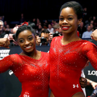 First placed Simone Biles, left, and second placed Gabby Douglas, right, both of the U.S., pose for the photographers after the women's all-around final competition at the World Artistic Gymnastics championships at the SSE Hydro Arena in Glasgow, Scotland, Thursday, Oct. 29, 2015. (AP Photo/Matthias Schrader)