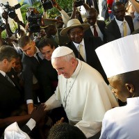 Pope Francis greets well-wishers on the streets of Kampala