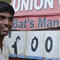 Schoolboy ‘bat’s man’ Pranav poses beside a scoreboard ill-equipped for his epic knock