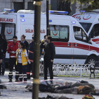 Emergency workers inspect the carnage following a suspected suicide bomb attack in the centre of Istanbul
